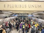 The crowd at 96th St Station surrounded by two regular Q trains 